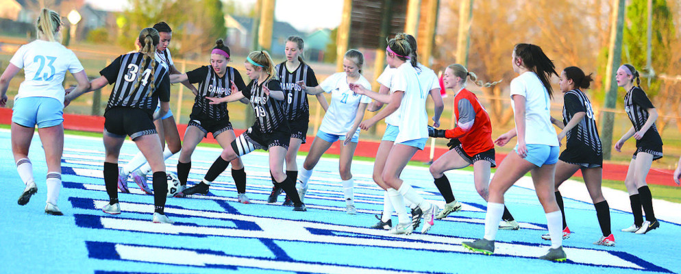 LEFT: The Eisenhower Tigers celebrate a second-half goal. Eisenhower put in nine goals against Campus. ABOVE: The Tigers and Colts battle in front of the goal during a game played in Clearwater. Stephanie McKennon/TSnews