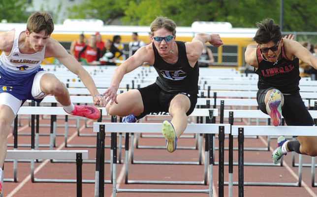 Justus Reynolds battles two competitors in the 110-meter hurdles. He placed third for Eisenhower, and was the first-place finisher in the 300-meter hurdles. Dale Stelz/TSnews