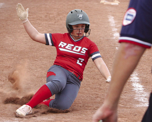 Reds’ player Brooke Beck slides safely into home for a run during last Thursday’s second game at Cheney, which swept the Reds in a double header. Travis Mounts/TSnews