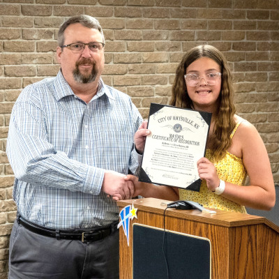 LEFT: Haysville Mayor Russ Kessler recognizes Ally Drake for her efforts in helping rescue a friend following a boating accident last month. RIGHT: Haysville police officer Le Von Crotts also was honored at Monday’s meeting by Derby/Haysville American Legion Post 408 as the Kansas Law Enforcement Officer of the Year. City of Haysville/Contributed photos