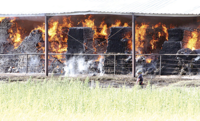 Fire rages through bales of hay at a late Sunday afternoon barn fire north of Garden Plain. Fire crews were on site overnight and into the day on Monday. Travis Mounts/TSnews