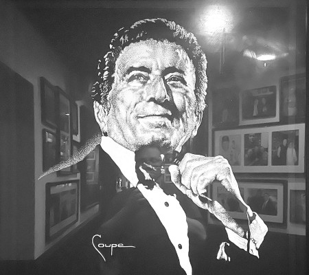 Garozzo’s restaurant in downtown Kansas City, Mo., has a large painting of the late Tony Bennett. To find the men’s room, take a left at Tony. Other artwork is reflected in the glass. Travis Mounts/TSnews