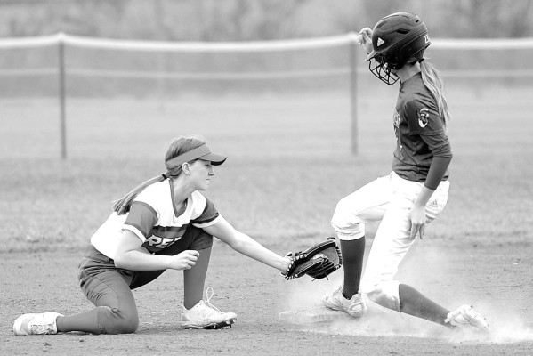 Dale Stelz/TSnews ABOVE: Conway Springs’ Regan May tries to tag out Karli Inslee of Cheney during last week’s matchup between the Central Plains Leage foes. LEFT: Erika Block lays down a bunt for Cheney during last Thursday doubleheader with Conway Springs.