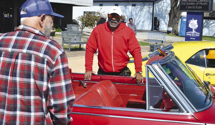 The third annual Larry Lee Memorial Car Show, hosted by the Goddard Lions Club, too, place Saturday in downtown Goddard. Ron Simpson was among the car owners to bring out their classic vehicles. He is seen visiting with a show attendee. Dale Stelz/TSnews