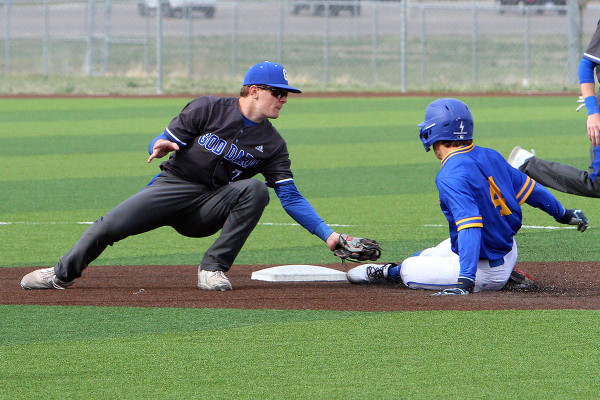 ABOVE: Goddard’s Nick Rogers applies a tag at second base during last Friday’s home double header against the Hutchinson Salthawks. LEFT: Sandler Bowyer beats the throw into third base. Dale Stelz/TSnews