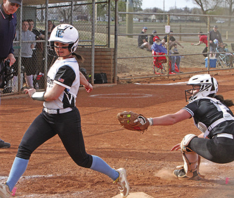 The Tigers’ Lanie Burkhart scoots past the attempted tag from Campus catcher Rylie Miller during the first game of Friday’s doubleheader in Haysville. The Tigers won the first game, but the Colts came back for a 12-11 victory in Game 2. Travis Mounts/TSnews