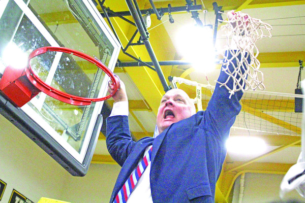 Campus Colts head basketball coach Chris Davis cuts down the nets following the Colts’ substate win over rival Derby in March 2020. The victory gave the Colts their first trip to State basketball in 24 years, and they finished the season with an undefeated 23-0 record. Travis Mounts/TSnews