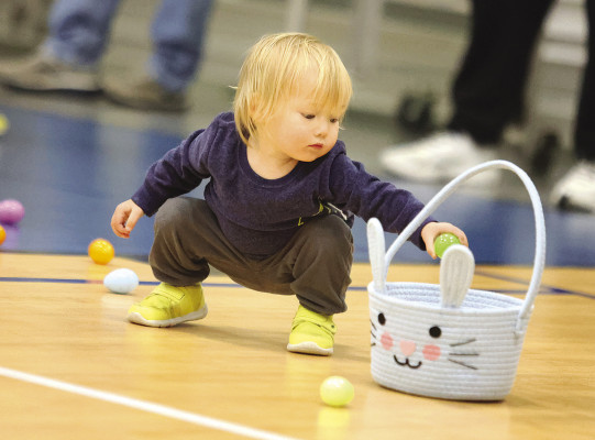 Elio Pulley, age 18 months, picks up eggs during Haysville Recreation’s Easter egg hunt on Sunday. Inclement weather moved the event inside to the Haysville Activity Center. See more photos on Page B1. Stephanie McKennon/TSnews