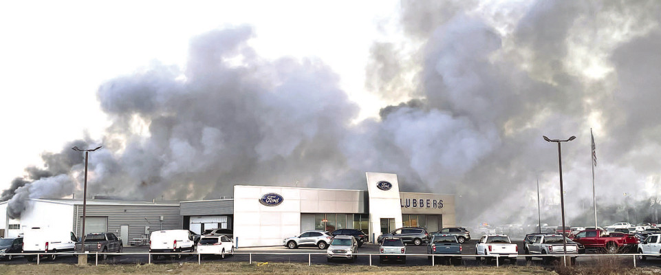 Smoke pours out of the Lubbers Ford service building, which is on the back side of the Ford sales building in Cheney. Firefighters contained the blaze in about 20 minutes. Travis Mounts/TSnews