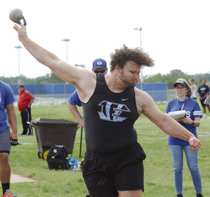 LEFT: Jaden Cohens competes in the long jump during the Goddard Lions’ home track meet last Friday. RIGHT: Travis Nicholson of Eisenhower throws the shot put during the track meet at Goddard. Nicholson did not place in this event, but he did take third in the discus. Dale Stelz/TSnews