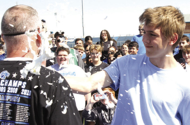 ABOVE: Goddard High School principal Doug Bridwell takes a pie to the face at GHS' world record attempt. BELOW: Math instructor Joel Burgeson organized Friday’s Guinness World Record attempt at the most people making a pi symbol. Travis Mounts/TSnews