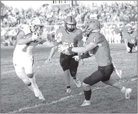Jack Voth of the Cheney Cardinals fights off a pair of Kingman receivers during last Friday’s victory over the Eagles. Voth was the Cardinals’ leading rusher, thanks to a 79-yard touchdown run. Andrea McDaniel/Contributed photo