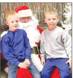 ABOVE: Lucas and Evan Dawson were among the first children in line to visit with Santa Claus at Come For Christmas in Cheney. Events included cookie decorating, wagon rides, visits with Santa, chaos from The Grinch and Buddy the Elf, and business open houses. See more photos online at tsnews.com. BELOW: Brinley and Will Langerot pose together at the cookie decorating station, which was located inside Citizens State Bank. The event drew a good crowd. Travis Mounts/TSnews