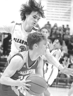 Trent Fisher of Clearwater closely guards a Wellington player last Friday.