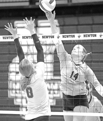Mindy Tillotson (8) of Goddard goes up to block a ball from Eisenhower’s Callie Gumm during the teams’ recent head-to-head match in Newton. Preston Barger/Contributed photo
