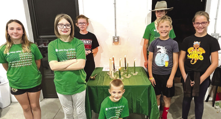 The new 4-H officers gather around the candle-lit table for a group picture after the ceremony Oct. 20. Several officers are returning, but a few are new or in new positions for this year. Contributed photo