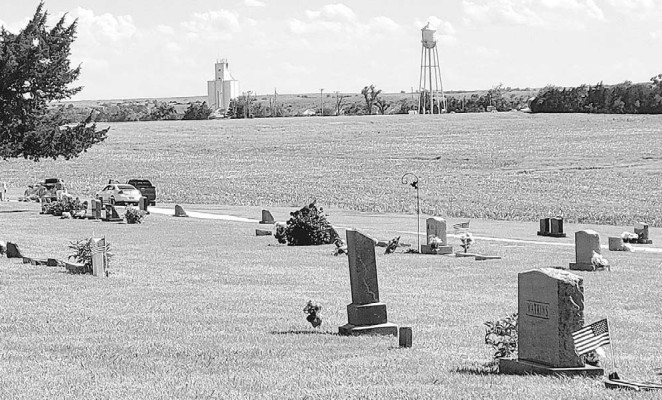 Publisher Paul Rhodes and his daughter Abby spent a lot of time during their ancestry trip in the Gaylord Cemetery, nestled among wheat fields in Smith County. The community of Gaylord sits in the distance. Paul Rhodes/TSnews