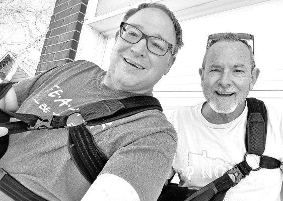 Brad Cline, left, and publisher Paul Rhodes snapped a photo Sunday to document their unusual situation: similar rotator cuff surgeries just a few days apart. Contributed photo