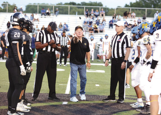 ABOVE: Dan Wheeler performs the coin toss before kick of the Campus Colts vs. Hutchinson Salthawks homecoming game. Wheeler, an alumni member of the class of 1974, was chosen by his classmates for the honor. BELOW: Former Campus High football players who were members of the class of 1984 were recognized at the start of Friday night's football game at Colt Stadium. Stephanie McKennon/TSnews