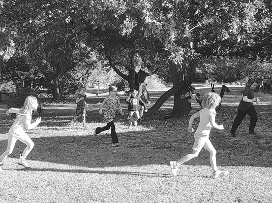 The girls participating in the scavenger hunt rush to get to their next clue, as the boys try to catch up. The girls won this competition. Angi Harlan/ Contributed photo.
