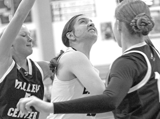 Kenzie Lever of Campus battles two Valley Center defenders during the Colts’ homecoming game last Friday in Haysville. Travis Mounts/TSnews