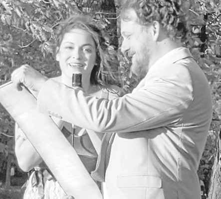 Katie Rhodes, daughter of publisher Paul Rhodes, shares her wedding vows with Rob Hornstra during their recent wedding at Clinton Lake near Lawrence, Kan. Paul Rhodes/TSnews