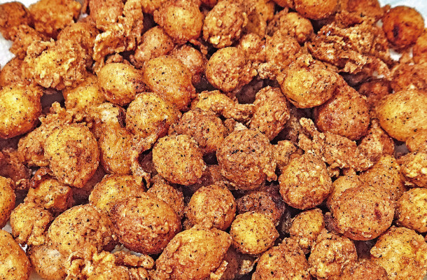 Mini blooming onions are pearl onions that are battered and fried to create the same great flavor as the classic carnival dish without all the effort and mess.