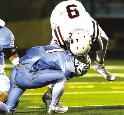 Joe Santillan makes a tackle during Eisenhower’s playoff victory against the Topeka Seaman Vikings on Friday. The Tigers are now one win away from playing in their first-ever football State championship. Matt Bucher/TSnews