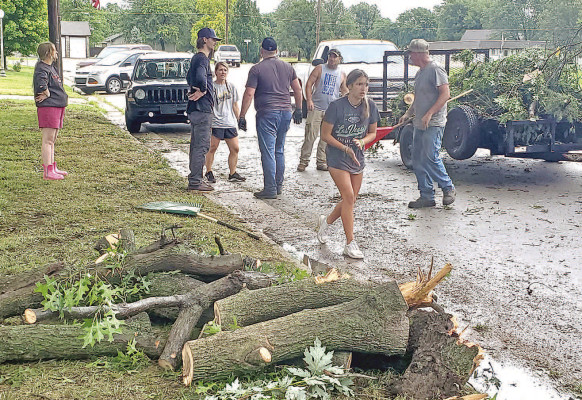Volunteers turned out all day last Wednesday to help Garden Plain residents clean up downed trees and limbs following a violent wind storm that hit the community that day. Paul Rhodes/TSnews