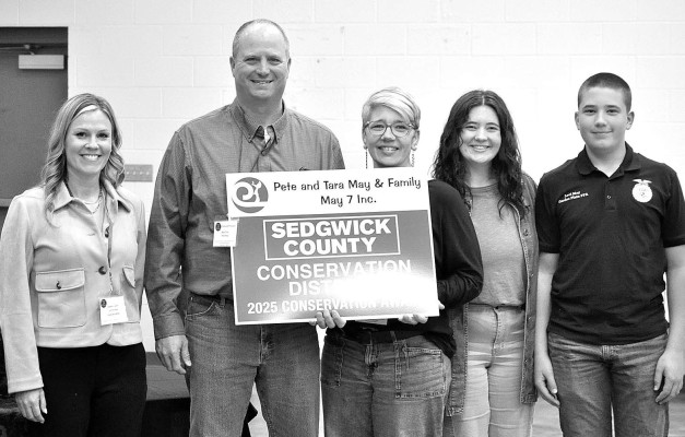 Pete and Tara May, along with family members, receive the Conservation Award at the annual meeting for Sedgwick County. Paul Rhodes/TSnews