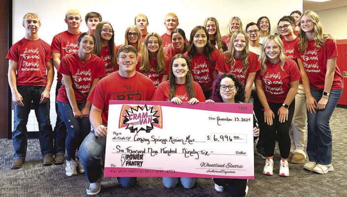 Student council members from Conway Springs High School pose with a check showcasing the $6,996 raised through the collaborative efforts of the Cardinals Care food drive and Power the Pantry campaign, benefitting the Conway Springs Mission Mart. Alongside this monetary donation, students across Conway Springs also contributed 1,517 food items to further support the cause. Contributed photo