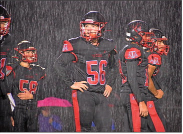 Spencer Beck, center, and other members of the Titans get ready for a playing in the pouring rain Friday at Argonia. The Titans won. They will host Central Burden this Friday in Attica. Savannah Shively/Contributed photo