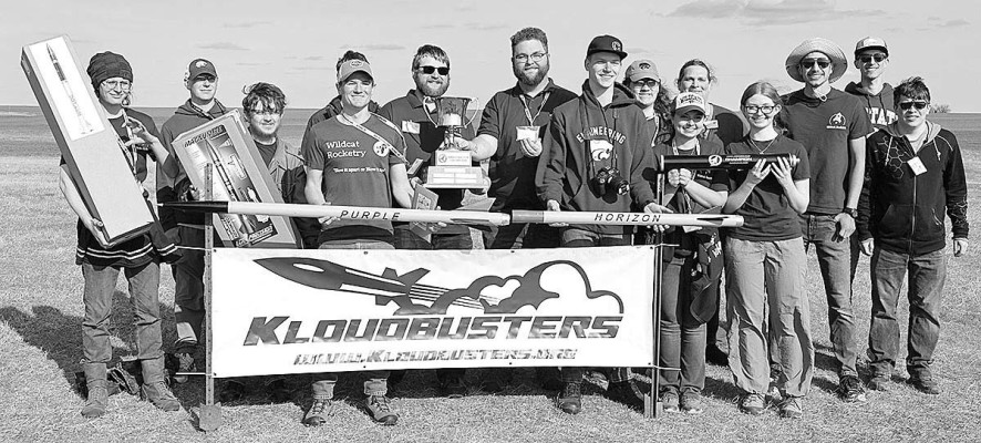 Members of the Wildcat Rocketry team pose with the Argonia Cup trophy and competition rockets, including the winning “Purple Horizon” rocket, which broke a world record for altitude for a commercial-staged L-impulse rocket by reaching an altitude of 35,439 feet. Contributed photo