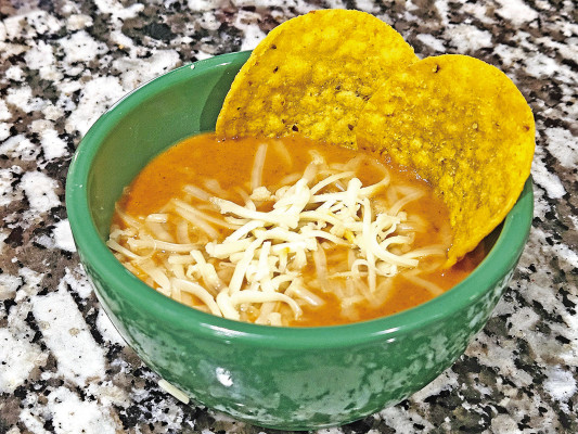 Frijoles puercos, or “piggy beans,” are made with five pork products, along with some fresh veggies and plenty of cheese. It’s good on tacos or other dishes or just as a bean dip, served with tortilla chips.