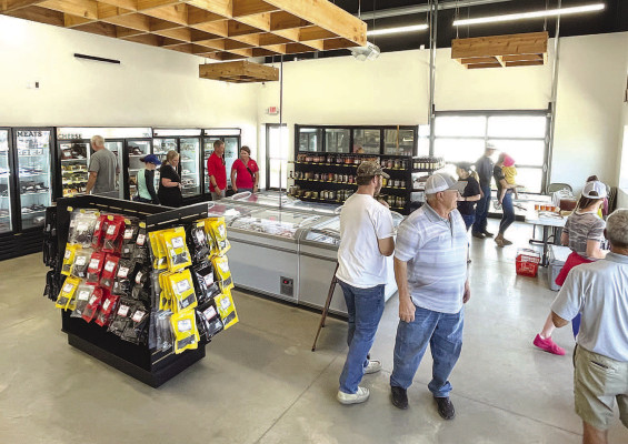 Customers shop inside the new and recently-opened retail space at Stroot Lockers in Goddard. The longtime locally-owned business now has 1,300 square feet of shopping space, a marked improvement over the old space, which was just a little more than 200 square feet, or the size of a bedroom. Travis Mounts/TSnews