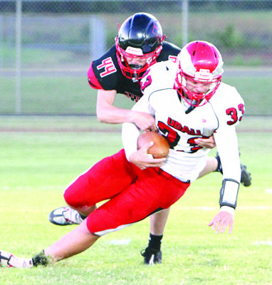 The Titans’ Carter Swingle sacks Udall’s Jenson Harness for a loss during last Friday’s victory in Argonia. Travis Mounts/TSnews