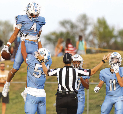 Matt Buchar lifts Carter Pabst following an Eisenhower Tigers touchdown against the rival Goddard Lions. Pabst caught three first-half touchdowns from quarterback Derek Morgan. Matt Buchar/TSnews