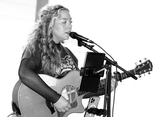 Katie Ziegler of Kingman performs on Saturday night at City Park in Garden Plain. Ziegler was the first performer in the city's new concert in the park series. The event drew several dozen audiences members on a pleasant summer evening. Mayor Kevin Hammond said he was pleased with the turnout. More concerts are being planned. Travis Mounts/TSnews