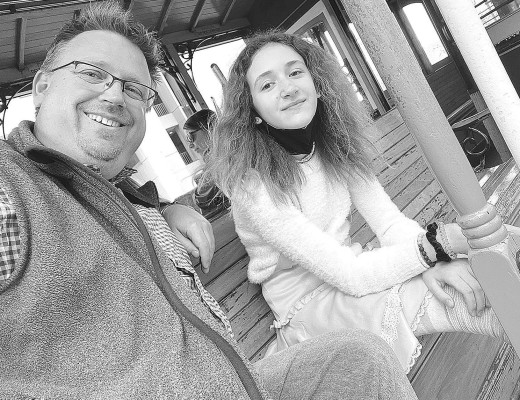 Managing Editor Travis Mounts and his niece, Juliette, take a ride on a San Francisco cable car.