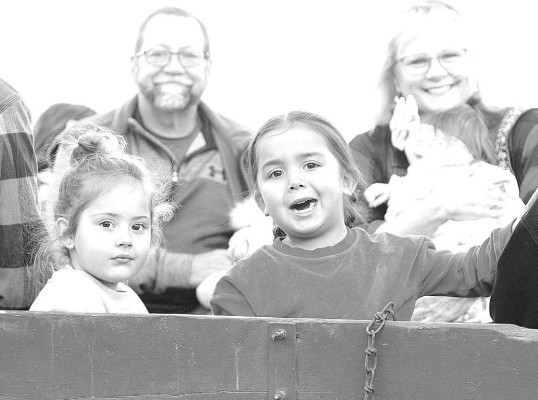People enjoy a horse-drawn wagon ride during this month’s Come Home For Christmas in Cheney. Travis Mounts/TSnews