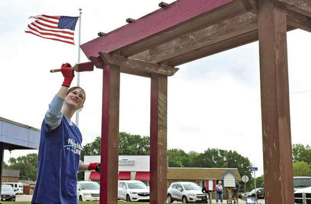 Volunteer Tori Treadwell does some paint work at the Goddard Public Library on Saturday as part of Neighbors United. The annual service event took place on Saturday in Goddard. More than 200 volunteers came forward to complete 40 projects. Neighbors United is now a youth-led effort, with students from Goddard Public Schools organizing the long-running community effort. Greg Alexander/Contributed photo