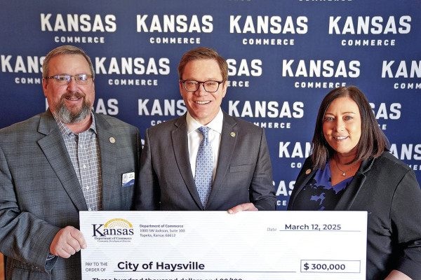 Lt. Gov. and Commerce Secretary David Toland, center, presents a ceremonial check to Haysville Mayor Russ Kessler and economic development director Danielle Gabor last week in Topeka. The City of Haysville is receiving a $300,000 grant to help residents improve their homes. Contributed photo