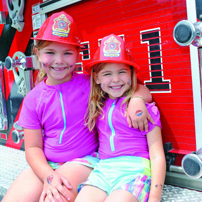 Beatrix and Genevieve Smothers sit together on a Clearwater Fire Department truck. The fire department held a new Fourth of July event on Saturday in Clearwater’s City Park. See more community Independence Day photos on Page B1. Dale Stelz/TSnews