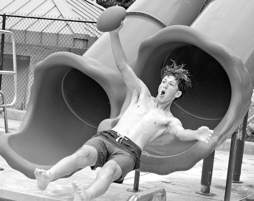 Bryce Christiansen flies out of a slide at the Clearwater Aquatic Center on July 4. The aquatic center held its annual Independence Day activities last Friday, with noodle races, a splash contest and greased watermelon contests. Dale Stelz