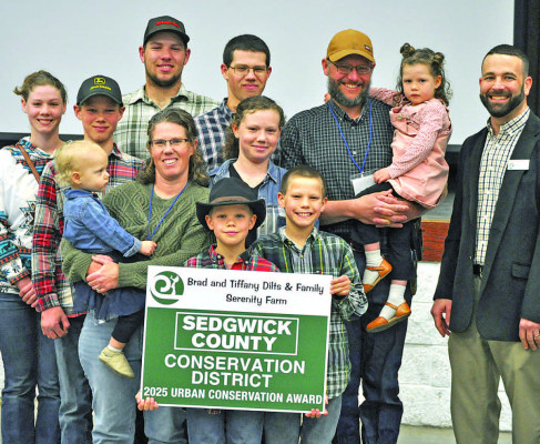 Brad and Tiffany Dilts of Serenity Farms, along with family members, receive the Urban Conservation Award at the annual meeting for Sedgwick County. Paul Rhodes/TSnews