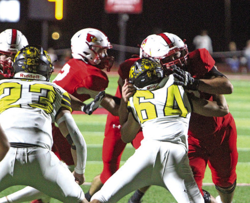 Defensive lineman Mason Phelps battles a Hoisington blocker during the first half of Friday’s Class 2A game. The Owls lost for just the second time all season. Travis Mounts/TSnews