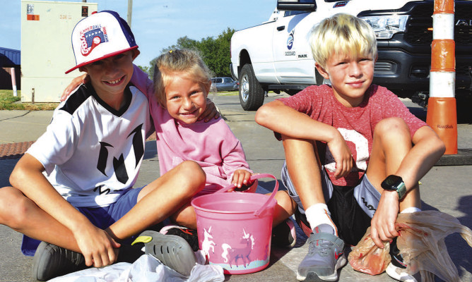 The Morris family children wait with candy bags and buckets in hand before the Goddard Fall Festival parade. The festival took place last Friday through Sunday, with most events taking place on Saturday. Many more photos will be posted online at tsnews.com. Dale Stelz/TSnews