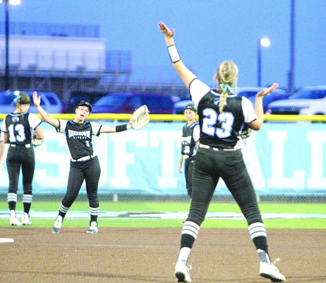 Lainie Burkhart, left, and Karli George of the Eisenhower Tigers dance to the song “Y.M.C.A.” between innings during last week’s Class 5A regional championship game. A 6-run first inning helped the Tigers to a victory and berth in the State softball tournament. Travis Mounts/TSnews