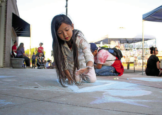Jasmine Lampe creates a chalk art drawing in downtown Clearwater on Friday night. The annual Clearwater Art Walk drew artists of all types, along with crafters and musicians. Near-perfect weather helped draw a good crowd. Travis Mounts/TSnews