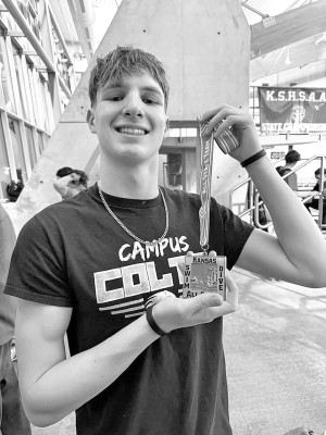 Cash Pegg-Westerhaus shows off his State swimming medal. He placed fifth in the 50-yard freestyle and eighth in the 100 freestuyle. Contributed photo